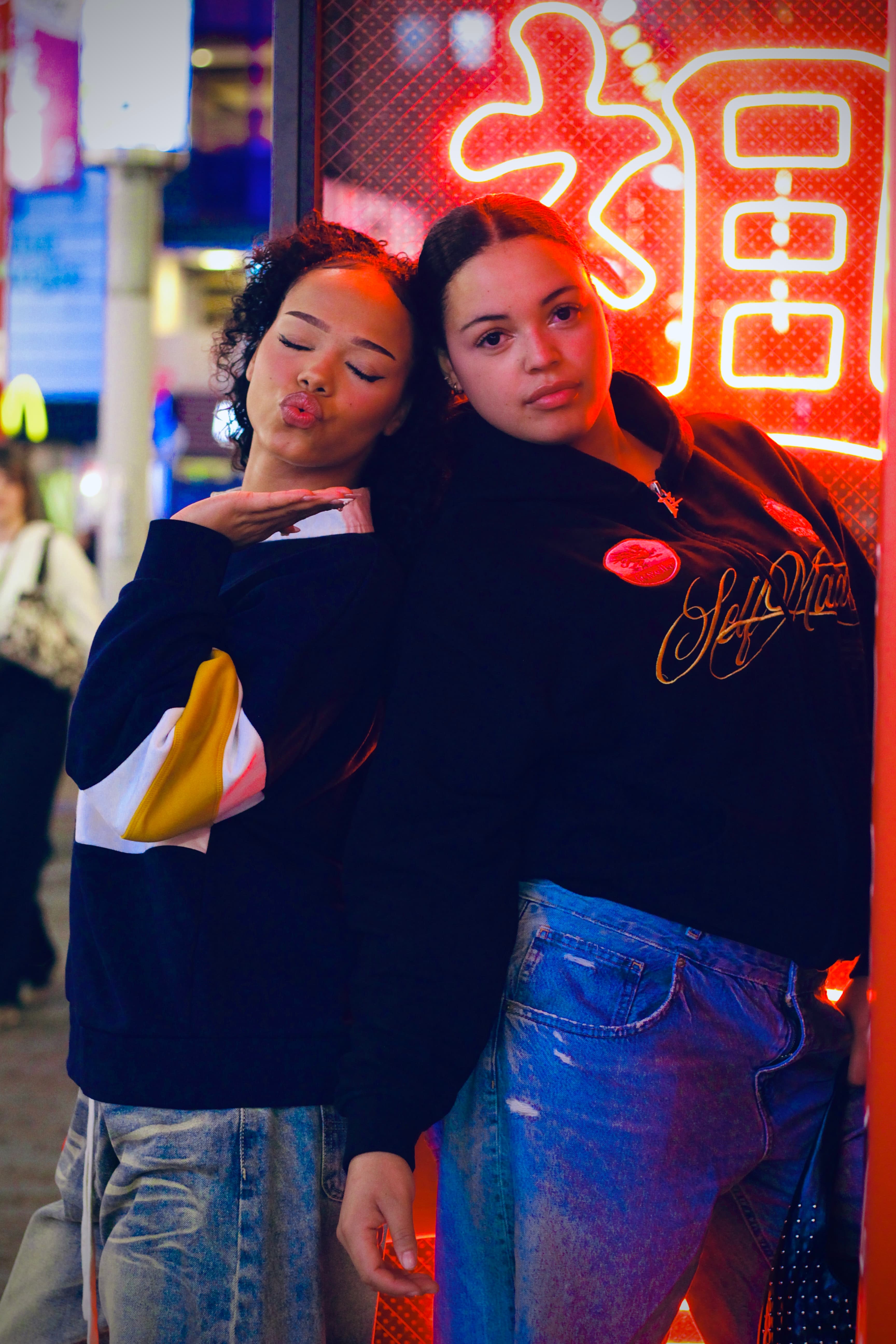 Neon portrait under red signage in Shinjuku